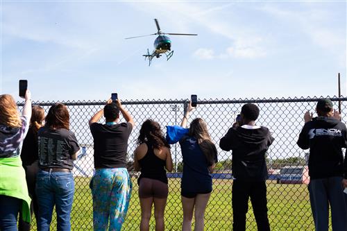 Students watching police helicopter land